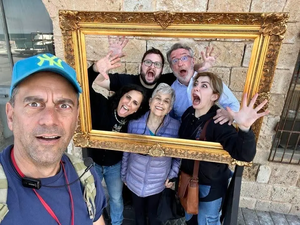 Robby and guests clowning around in a gold picture frame in Jaffa